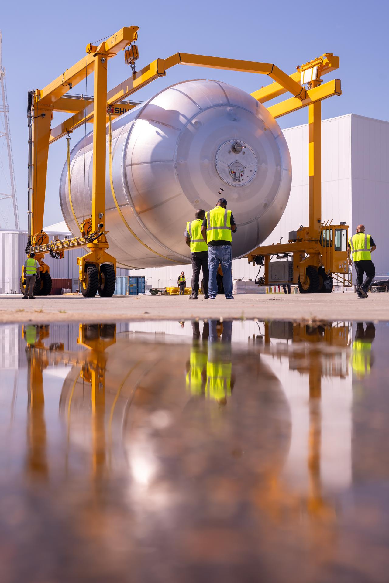 Teams at NASA’s Michoud Assembly Facility in New Orleans move a liquid oxygen tank from the main rocket factory into the adjacent vertical assembly building. The liquid oxygen tank, which will form part of the SLS (Space Launch System) rocket for NASA’s Artemis IV mission to the Moon, is rotated from a horizontal to a vertical configuration and loaded into the high bay’s hydrostatic proof testing cell. This non-destructive evaluation method tests the structural integrity of the tank’s welds by filling the tank with water, simulating the propellant used during launch. The propellant tank will hold more than 196,000 gallons of super-cooled liquid oxygen at launch and is one of five major elements that make up the 212-foot-tall SLS rocket stage. The core stage, along with its four RS-25 engines at its base, produces more than two million pounds of thrust to help launch NASA’s Orion spacecraft, astronauts, and supplies beyond Earth’s orbit and to the lunar surface for Artemis.
